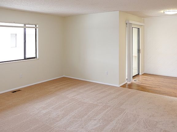 Living room and dining area with sliding patio doors to larg