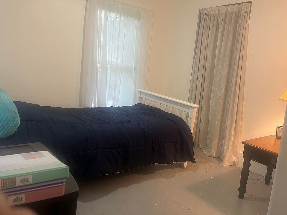 Bedroom number two which has a view of the backyard as well as the back deck