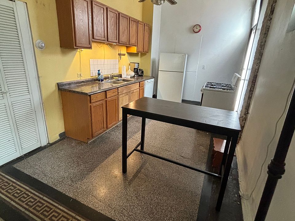 Kitchen cabinets are now white and new fan, fridge, dishwasher, and stove.
