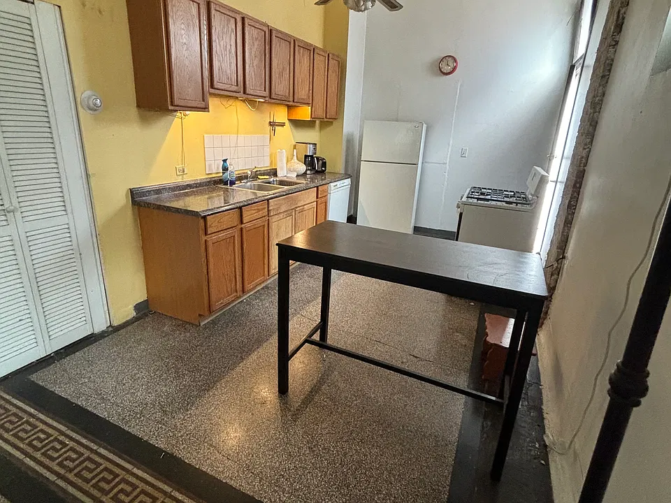 Kitchen cabinets are now white and new fan, fridge, dishwasher, and stove.