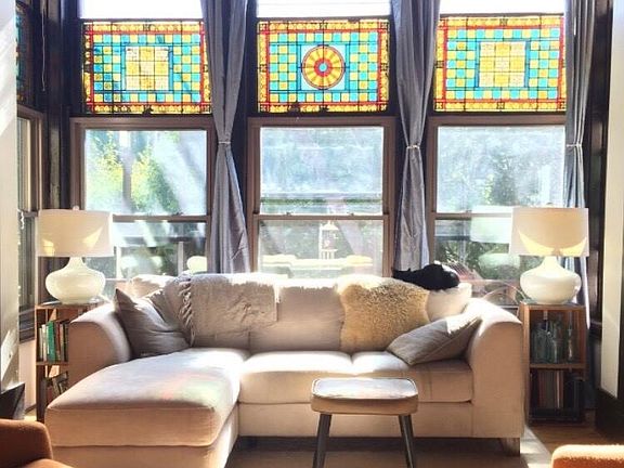 Living room w/ stained glass in bay window