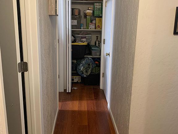 Hall to right of stairs. Laundry room left. Hall storage closet at end of hall
