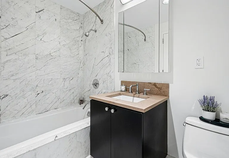 Elevate your daily routine in Arbor's modern bathroom, featuring elegant marble finishes and sleek cabinetry. Enjoy luxury and convenience in every corner. Schedule your visit today to see it in person!