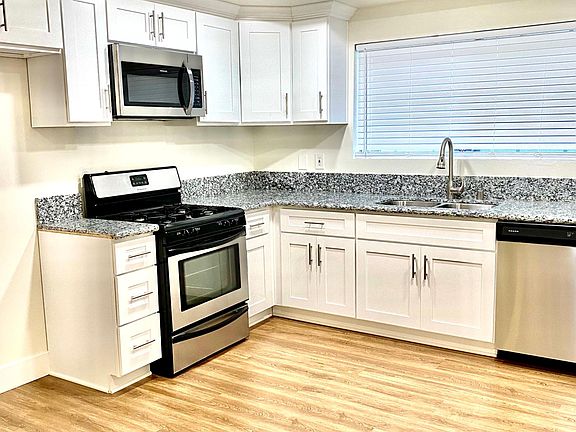 spacious new kitchen with granite counter, stainless appliances, laundry 110 volt electric hook up.