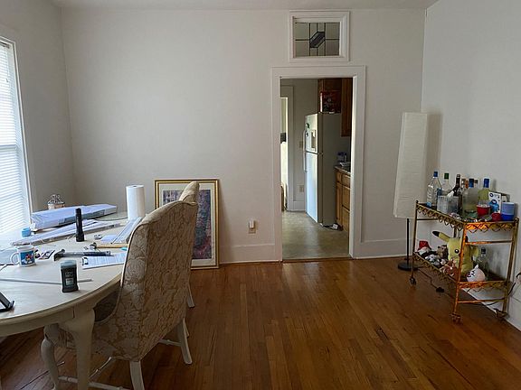 Dining Room - 9 ft. ceiling, original hardwood floors, French doors between living room and dining room, 2 large windows with blinds