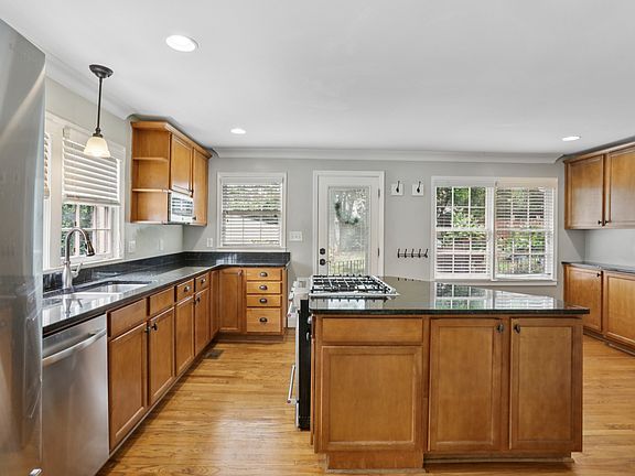 Large kitchen with island. Plenty of cabniet space and tons of natural light.