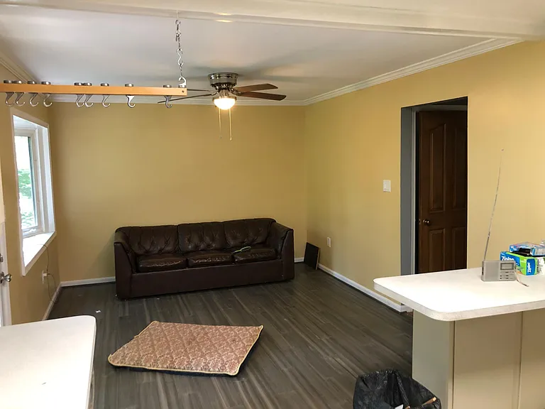 Looking to family room from kitchen, breakfast bar and passage to foyer and door to basement