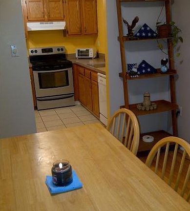 Dining area looking into kitchen. The kitchen was remodeled a few years ago with new cabinets (they are now white) and a new window.