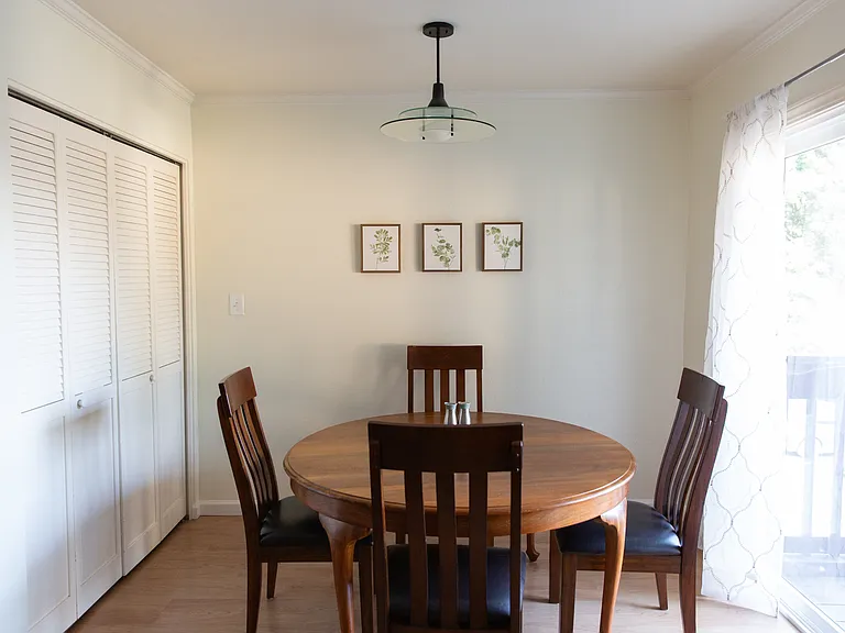 Dining area with laundry behind doors on the left.