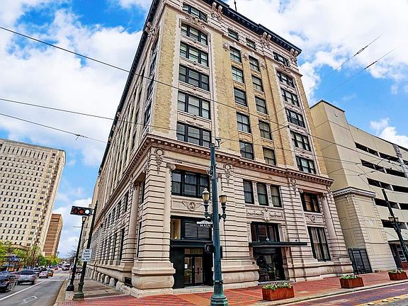 Franklin Lofts, formally the First National Bank building built in the early 1900s sits majestically at the corner of Main St & Franklin St on the MetroRail. The garage to the right is parking for the building.