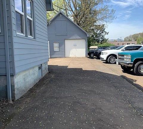 view of driveway and right side of house
