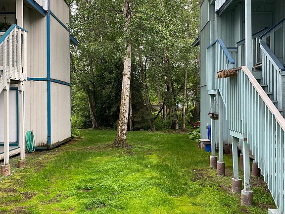 The backyard is heavily wooded and backs up to single family homes