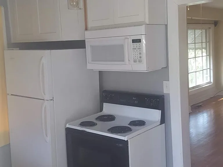 Additional storage above the fridge and the stove. Built In microwave for quick heating of food.