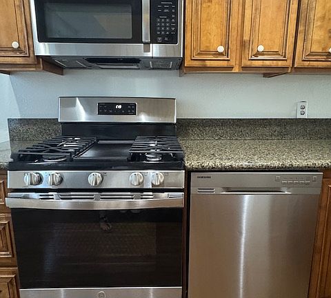 Stainless GE microwave, gas range and dishwasher