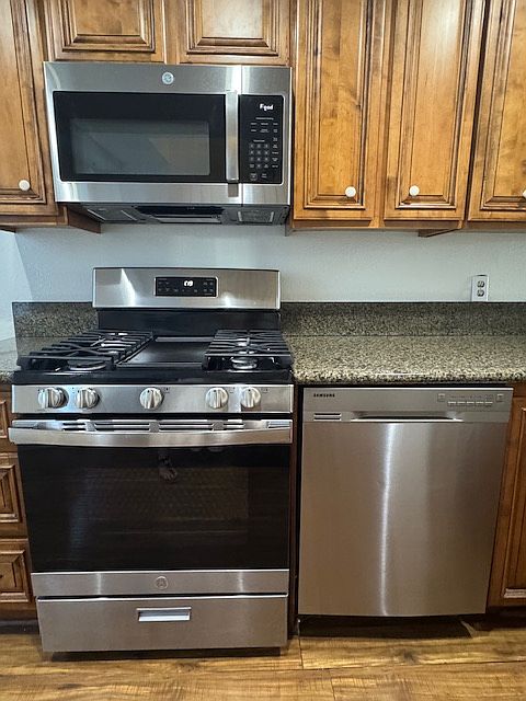 Stainless GE microwave, gas range and dishwasher