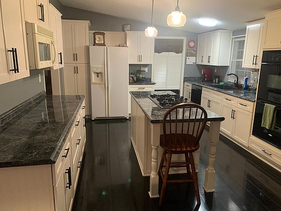 Fully updated kitchen with loads of countertop space, storage galore, and extra pantry space. Gas cooktop, double wall ovens, built-in microwave, stainless dishwasher, large updated double sink