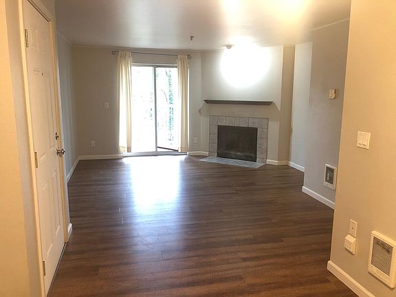 Living room with wood burning fireplace