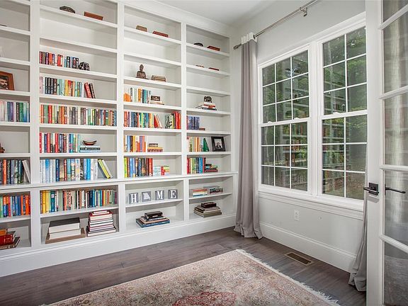The library/office with French doors is a cozy space to work or relax