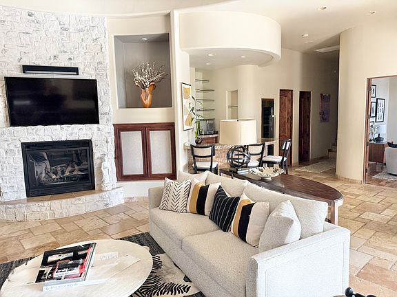 Great room with tile throughout connects to formal Dining room