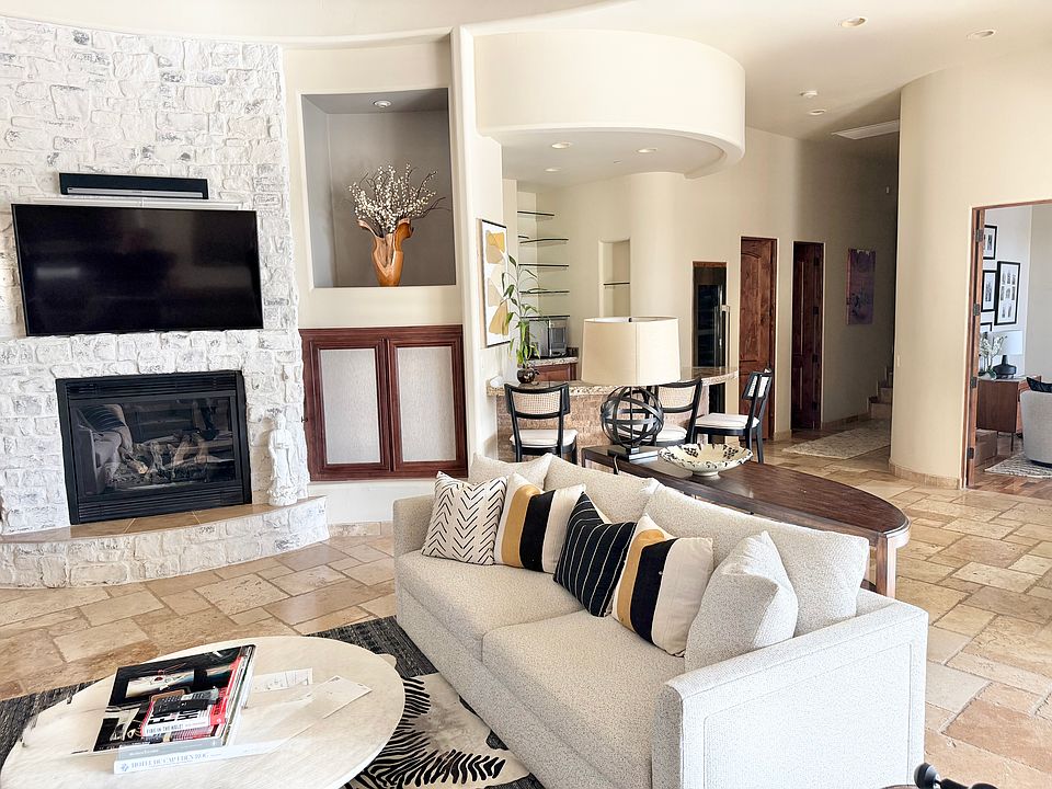 Great room with tile throughout connects to formal Dining room
