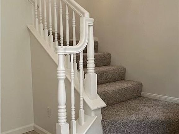 Foyer opens to stairs on right and coat closet under staircase, direct access to garage on the left.
