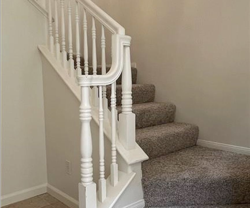 Foyer opens to stairs on right and coat closet under staircase, direct access to garage on the left.