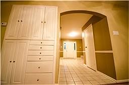 Custom built-ins and grand archway add even more personality to this great room