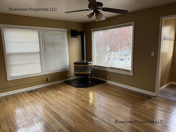 Main living area with propane stove and hardwood flooring
