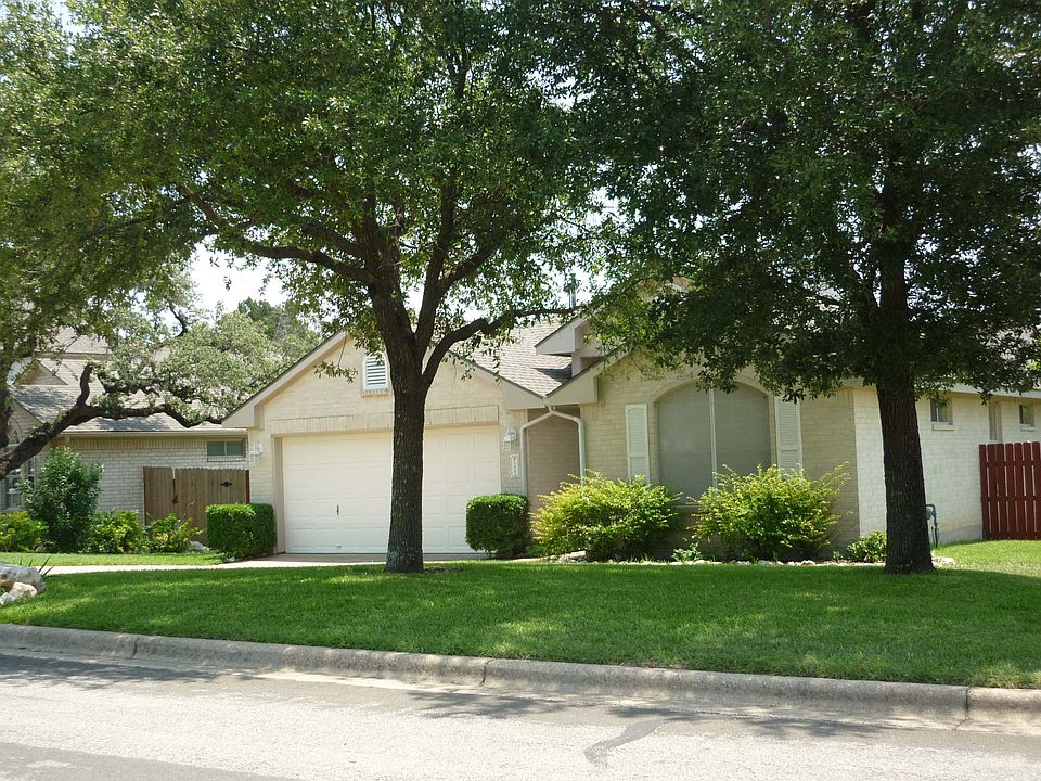 Street view of home, large oaks.