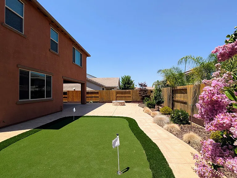 Resort-Style Backyard
Step into your private oasis featuring a pro putting green and built-in fire pit. Enjoy an elevated lifestyle in this meticulously maintained, tranquil sanctuary offering beauty and serenity without the hassle of yard maintenance.