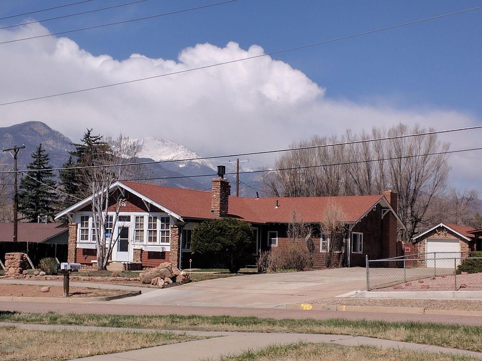 The house and Pikes Peak. Your wing is to the right. Your private entrance and patio are on the back side of that wing, at the end of the large driveway. Your carport is to the right of the stone garage. Your storage shed is just behind the carport.