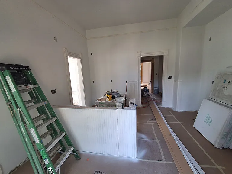 View into the kitchen entering from the french doors. Sink island to the left, stove and counter to the right.