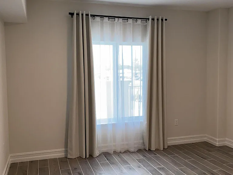 Master Bedroom with curtains for privacy and heat/light control.