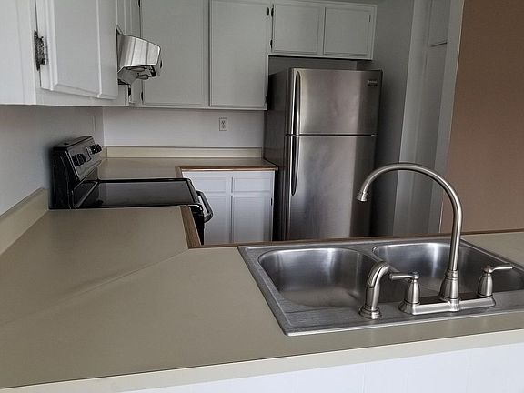 Kitchen with new sink, faucet, and garbage disposal