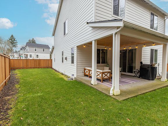 Back yard with 12ft extended back patio. Option to include outdoor furniture and Traeger.