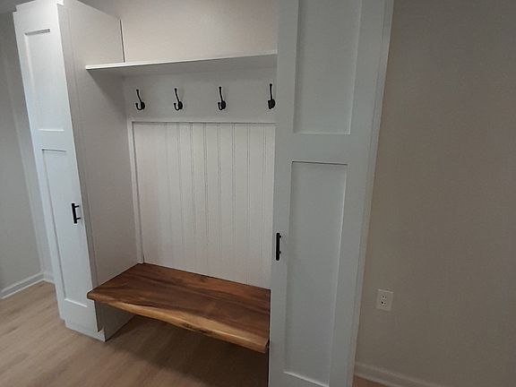 Built in bench and coatrack with extra storage closets