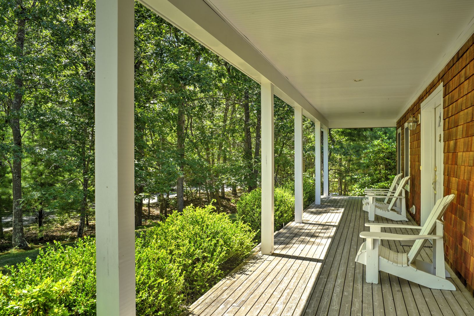  Relax on Adirondack chairs on the covered front porch