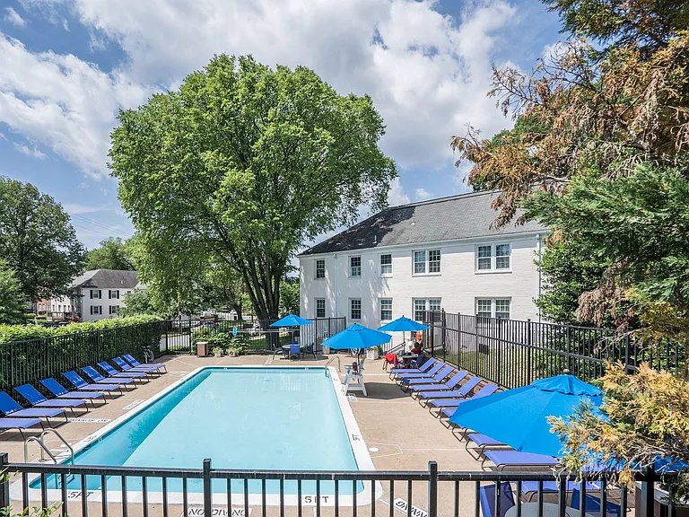 Community pool has lots of seating; fitness center in rear of building