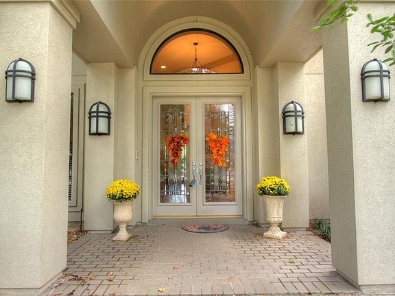Circle driveway, three car garage with epoxy flooring, covered front porch with inviting double door entry. Roof is less than 4 years old.