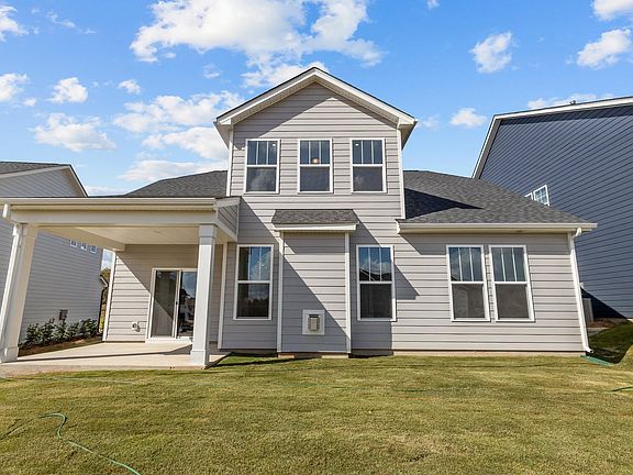 Fairfield design rear elevation with covered rear porch at Lakeside Glen by premier builder DRB Home