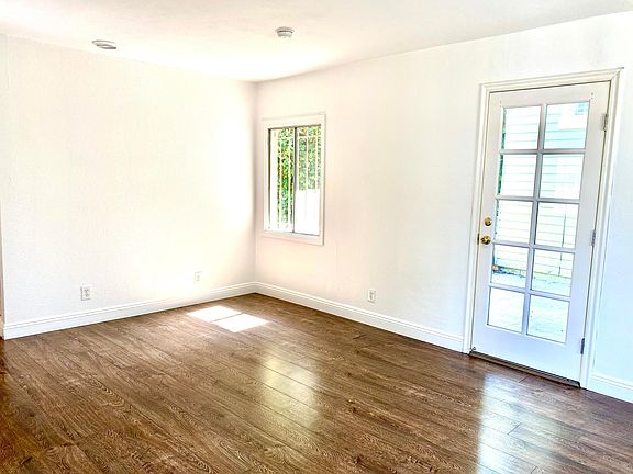 Living Room with Door to back patio and gated yard
