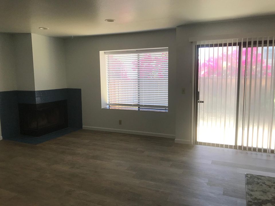 Living Area with fireplace opening up to the enclosed patio.