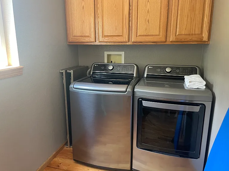 Laundry room -- newer washer and dryer. Nice storage in laundry area as well.