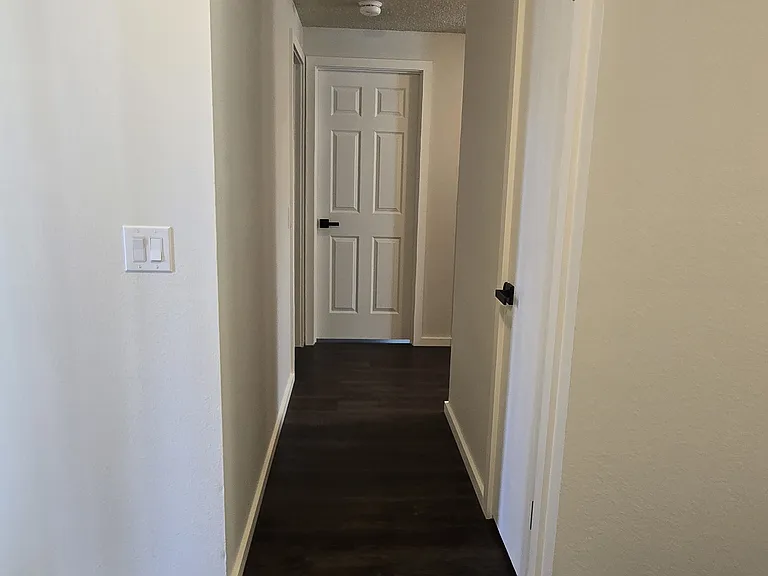 View from S. bedroom towards N. bedroom. (rug not included).