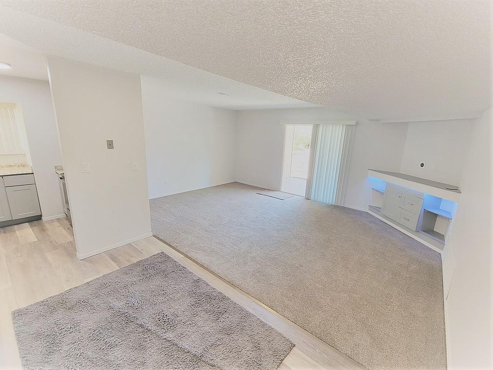 Solid Main Locked Entrance, Open living Room with built in Corner Entertainment center. 
Also has sliding glass door to patio and parking area, also has exterior storage.