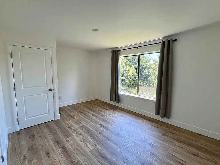 Bedroom with walk-in closet and laundry. This room is large enough for your king-size bed!