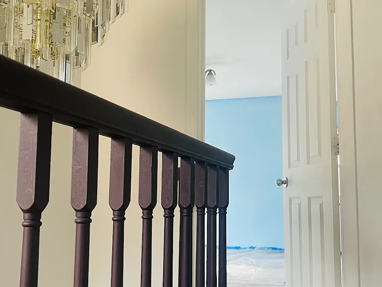 Sneak peak at the biggest bedroom. It's a beautiful blue (freshly painted) with white trim that really pops. Large closet, built-in bookshelf and the absolute best lake views right from your bed! This bedroom and the 4-seasons room in the front are fire!