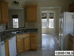 Kitchen has maple cabinets and refrigerator stays.