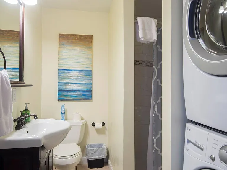 Second full bath off of kitchen with standing shower. Stacked laundry located here.