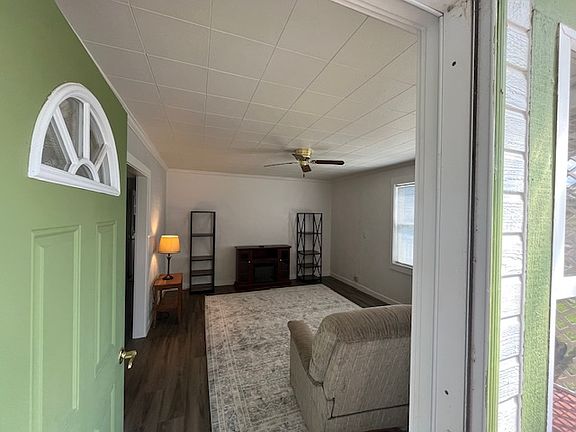 Partially furnished living room with fireplace/heater, new rug